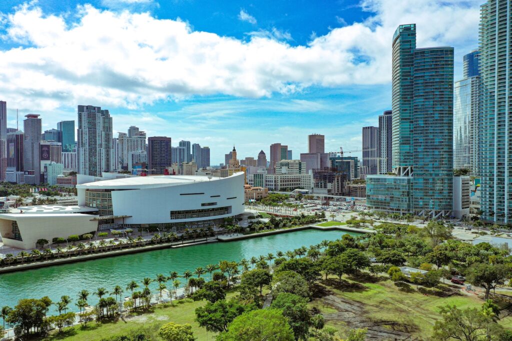 high rise buildings near green trees under blue sky during daytime