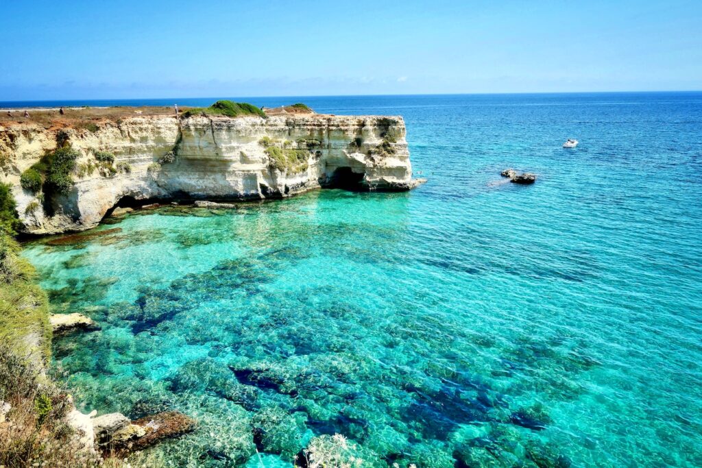 brown rock formation on blue sea during daytime